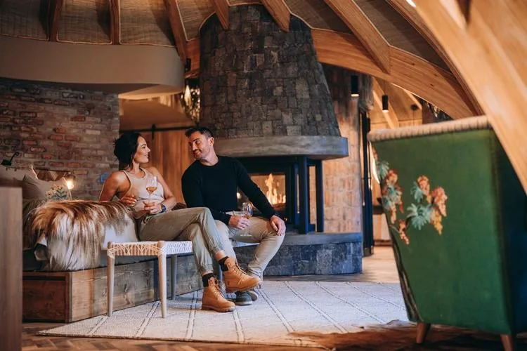 Guests relaxing by the fireplace at Wilderness Bisate Reserve