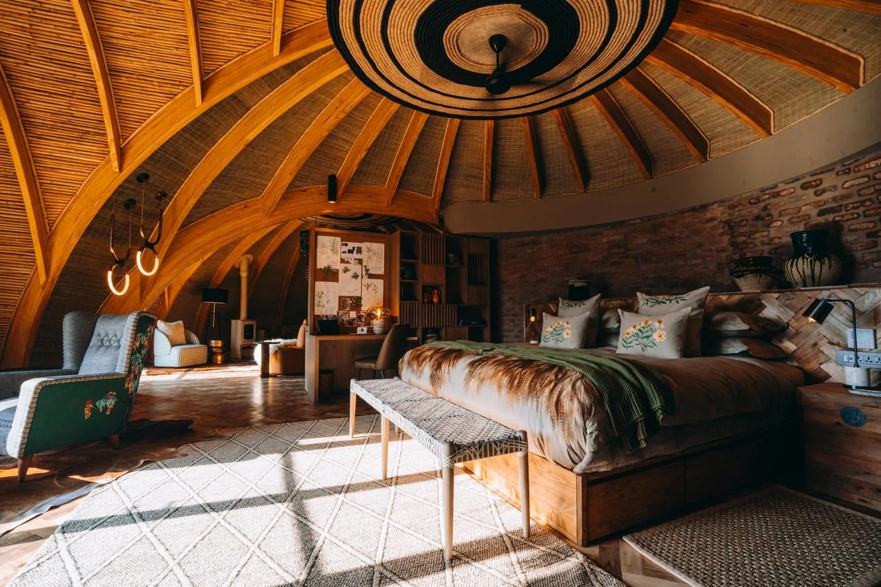 Bedroom and curved timber ceiling at Wilderness Bisate Reserve